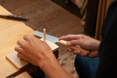 man using a Japanese saw