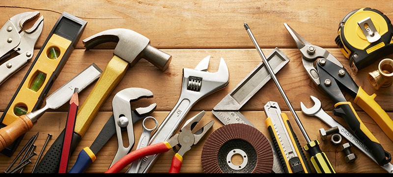 Top view of tools scattered on a work bench without organization