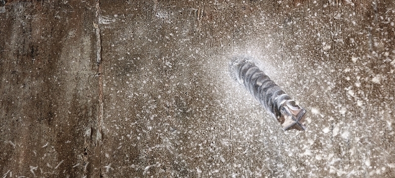 dewalt drill bit being drilled through a concrete wall