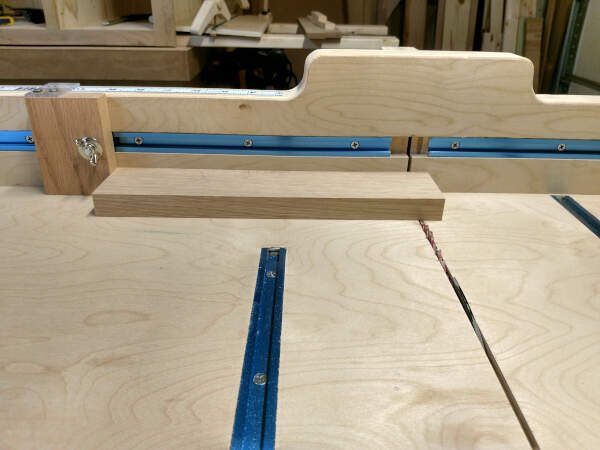 Using stop block to cut tongues on cabinet door rails